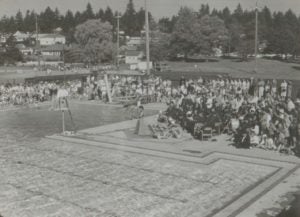 Old black and white photo of the original fircrest pool with spectators around it.